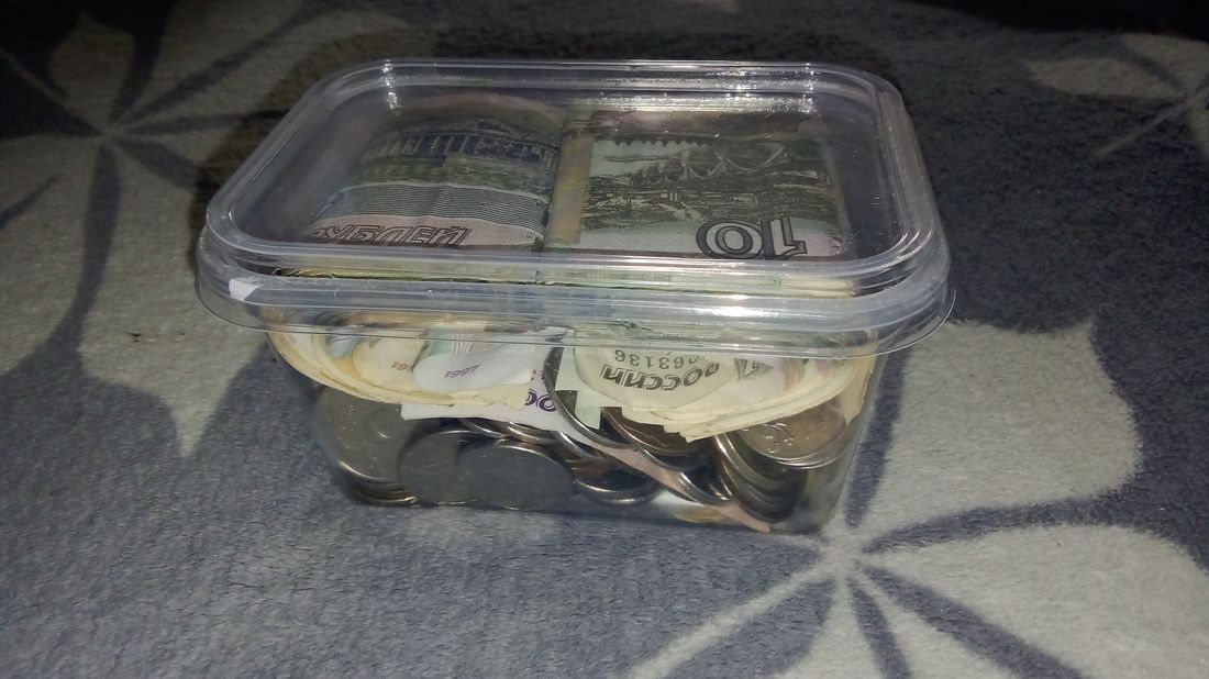 A plastic container used as a piggy bank