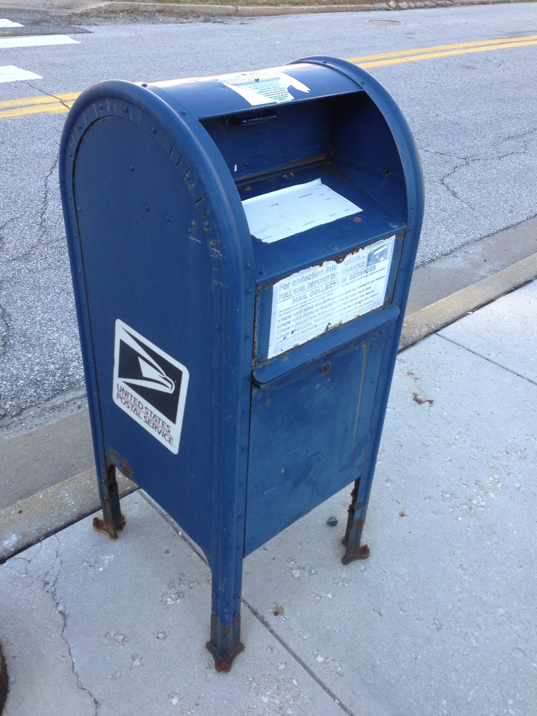 A blue United States Postal Service mailbox
